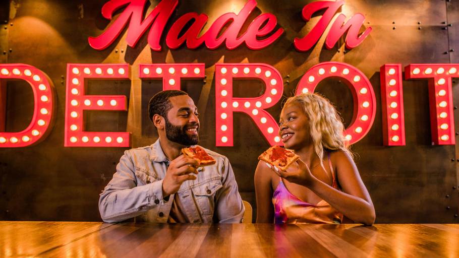 A couple enjoying Buddy's Pizza in Detroit, MI