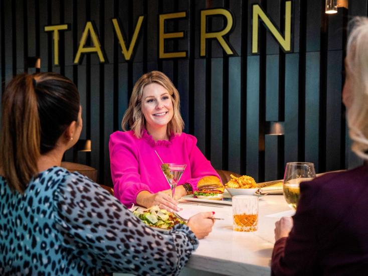 Women enjoying a drink and dinner at Tavern at the Hyatt Regency Jacksonville Downtown