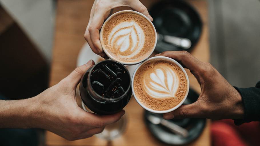 A group of friends having coffee and lattes.